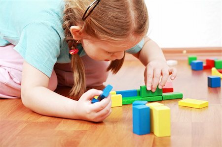 Adorable girl playing with blocks Stock Photo - Budget Royalty-Free & Subscription, Code: 400-04161269