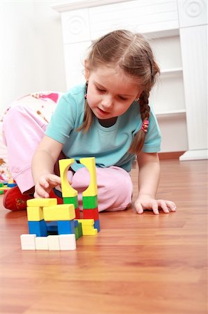 Adorable girl playing with blocks Stock Photo - Budget Royalty-Free & Subscription, Code: 400-04161270