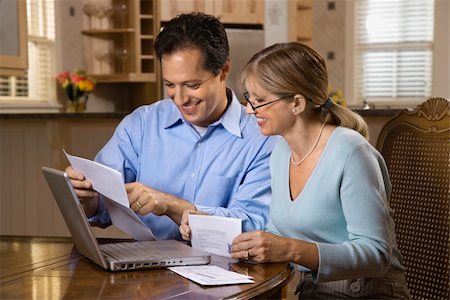 Couple paying bills online with laptop computer at home. Stock Photo - Budget Royalty-Free & Subscription, Code: 400-04162410