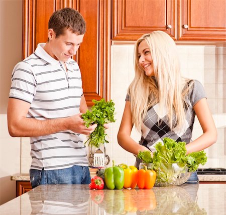 simsearch:400-04162443,k - Young couple in the kitchen enjoy making a salad with fresh vegetables. Square shot. Fotografie stock - Microstock e Abbonamento, Codice: 400-04162432