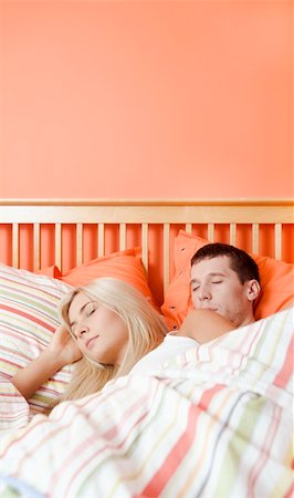 Young couple sleep closely together under a striped bedspread. Vertical shot. Stock Photo - Budget Royalty-Free & Subscription, Code: 400-04162578