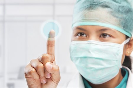 female medical worker or reseacher or scientist touching virtual button panel Photographie de stock - Aubaine LD & Abonnement, Code: 400-04163266