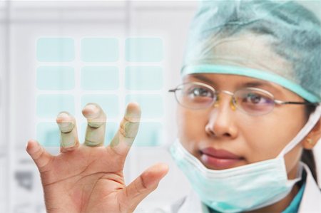 surgeon access - female medical worker or reseacher or scientist touching virtual button panel Stock Photo - Budget Royalty-Free & Subscription, Code: 400-04163269