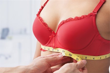 Measuring bust base size of woman wearing red bra Stock Photo - Budget Royalty-Free & Subscription, Code: 400-04163273