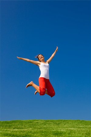simsearch:400-06077546,k - Beautiful young woman jumping on  a green meadow Stockbilder - Microstock & Abonnement, Bildnummer: 400-04174012
