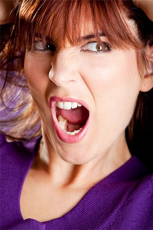 person screaming pulling hair - Beautiful woman with a angry expression pulling her hair Stock Photo - Budget Royalty-Free & Subscription, Code: 400-04174049