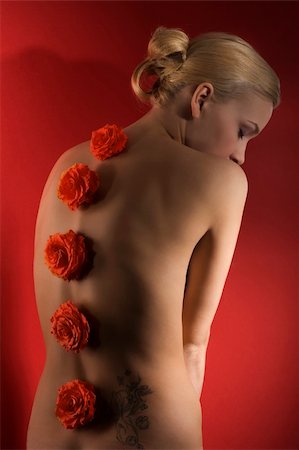 simsearch:400-04346129,k - cute blond girl on red background with some flowers on her back taking a pose arching her back Stock Photo - Budget Royalty-Free & Subscription, Code: 400-04174211