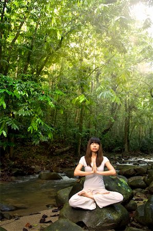 an asian female practising yoga inside a beautiful green forest Stock Photo - Budget Royalty-Free & Subscription, Code: 400-04174732