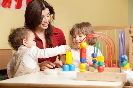 female toddler and 2-3 years girl playing with blocks toy in kindergarten. Horizontal shape Stock Photo - Budget Royalty-Free & Subscription, Code: 400-04174894