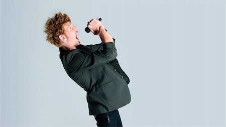 Rock star jumps and sings into the mic Stock Photo - Budget Royalty-Free & Subscription, Code: 400-04175899