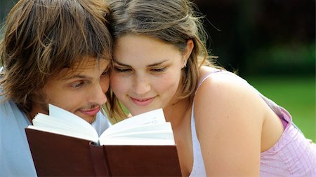 Attractive couple read together in the park Stock Photo - Budget Royalty-Free & Subscription, Code: 400-04175935
