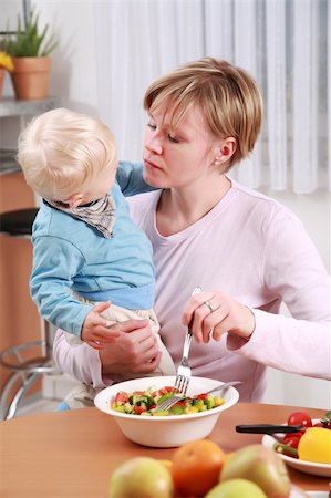 dinner with family and a baby - Little boy tasting vegetable salad with his mother Stock Photo - Budget Royalty-Free & Subscription, Code: 400-04176143