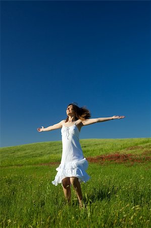 Beautiful happy young woman dancing on the field Stock Photo - Budget Royalty-Free & Subscription, Code: 400-04176228