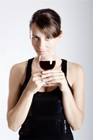 simsearch:400-04793100,k - Beautiful young woman wearing a sexy evening dress and drinking  a wineglass Foto de stock - Super Valor sin royalties y Suscripción, Código: 400-04176301