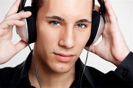 Portrait of a young man listening music with headphones Stock Photo - Budget Royalty-Free & Subscription, Code: 400-04176337