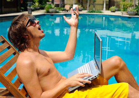 simsearch:400-05209351,k - Attractive man on holiday is frustrated at the pool Stock Photo - Budget Royalty-Free & Subscription, Code: 400-04176365