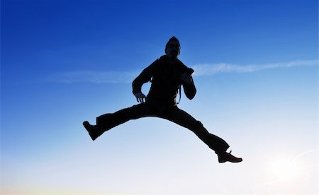 simsearch:400-04563369,k - jump! silhouette of a young male jumping over blue background Photographie de stock - Aubaine LD & Abonnement, Code: 400-04176711