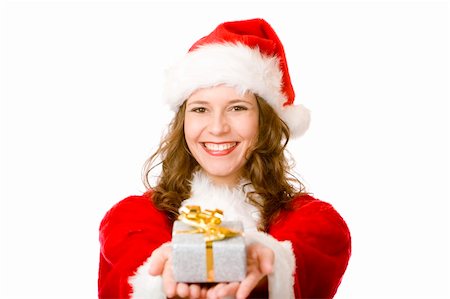 simsearch:400-07332398,k - Young women in Santa Claus dress is holding a Christmas present on her ear, to find out what is inside. Isolated on white. Photographie de stock - Aubaine LD & Abonnement, Code: 400-04176795