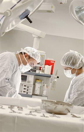 simsearch:400-04177437,k - Two surgeons working at the operating room Photographie de stock - Aubaine LD & Abonnement, Code: 400-04177438
