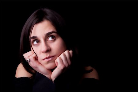 Pretty young woman with curious look. Black background. Studio shot. Stock Photo - Budget Royalty-Free & Subscription, Code: 400-04178182