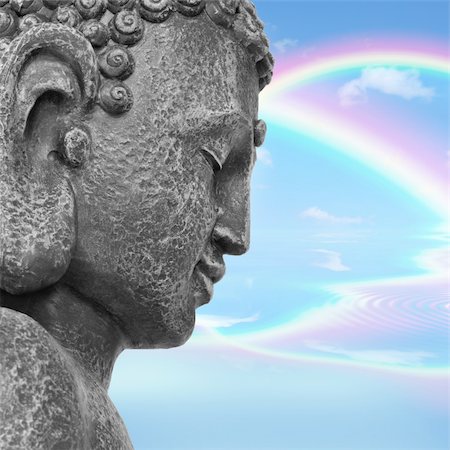 simsearch:400-05099216,k - Face of a buddha with eyes closed in prayer, with a blue sky and double rainbow in reflection in the distance, symbolising nirvana.  Side view. Mass produced statue. Stock Photo - Budget Royalty-Free & Subscription, Code: 400-04178519