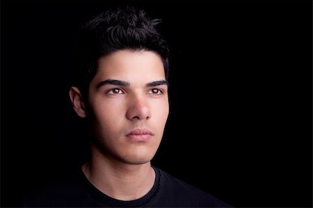 Portrait of a handsome young man on black background. Studio shot. Photographie de stock - Aubaine LD & Abonnement, Code: 400-04179497