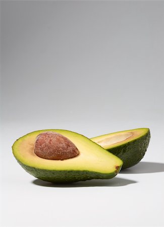 Close-up of cut avocado on white Stock Photo - Budget Royalty-Free & Subscription, Code: 400-04170119