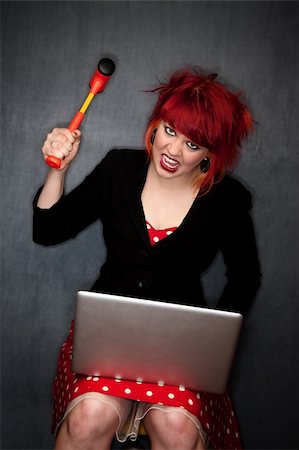 simsearch:400-06330521,k - Pretty punky girl with brightly dyed red hair with laptop computer Photographie de stock - Aubaine LD & Abonnement, Code: 400-04170438