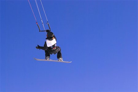 kiter with snowboard flying on the clear blue sky Stock Photo - Budget Royalty-Free & Subscription, Code: 400-04170799