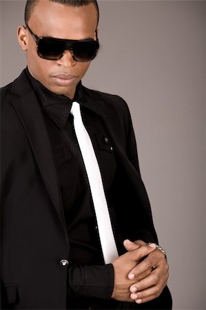simsearch:400-04674632,k - Portrait of young african business man in formal clothing on a grey background Foto de stock - Super Valor sin royalties y Suscripción, Código: 400-04171474