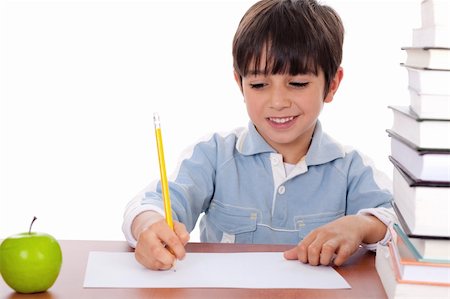 simsearch:400-04222125,k - School boy doing his homework with an apple beside him on white background Photographie de stock - Aubaine LD & Abonnement, Code: 400-04171495