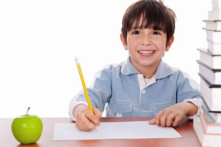 simsearch:400-04622918,k - School boy doing his homework with an apple beside him on white background Stock Photo - Budget Royalty-Free & Subscription, Code: 400-04171496