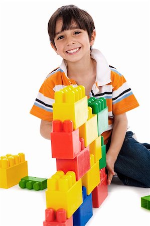 plastic toy family - Young boy playing with building blocks on white background Stock Photo - Budget Royalty-Free & Subscription, Code: 400-04171507