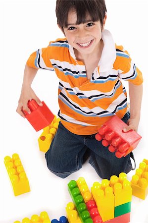 plastic toy family - Young boy playing with building blocks on white background Stock Photo - Budget Royalty-Free & Subscription, Code: 400-04171508