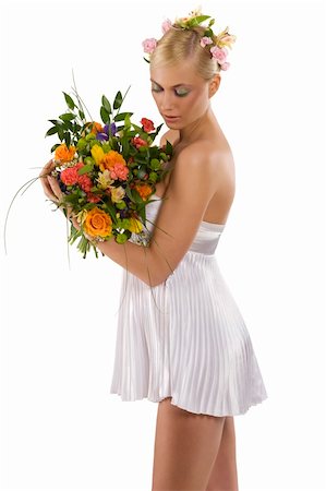 simsearch:400-05201906,k - nice shot of young and beautiful woman in short white dress looking at her flowers bouquet Stockbilder - Microstock & Abonnement, Bildnummer: 400-04172179