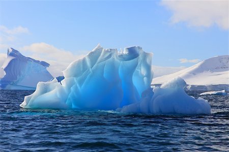 Luminescent Iceberg in Antarctica with sunlight Fotografie stock - Microstock e Abbonamento, Codice: 400-04172486