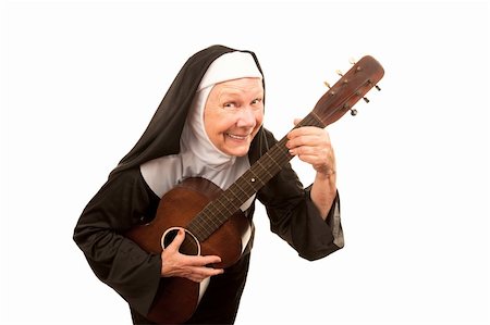 eccentric elderly people photos - Funny singing nun with old guitar and religious habit Stock Photo - Budget Royalty-Free & Subscription, Code: 400-04172739