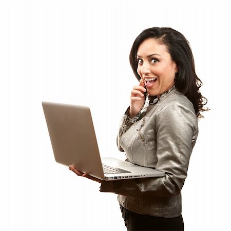 Shocked but interested Hispanic woman with laptop Stock Photo - Budget Royalty-Free & Subscription, Code: 400-04172753