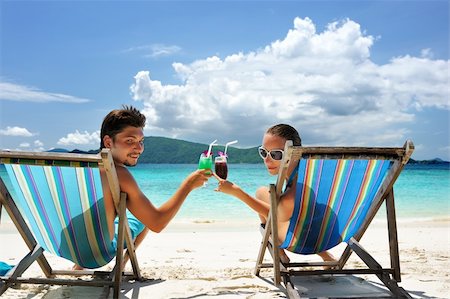 Couple on a tropical beach in chaise lounge Stock Photo - Budget Royalty-Free & Subscription, Code: 400-04172871