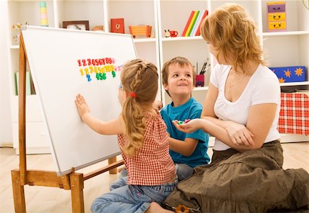 simsearch:400-06950074,k - Preschool kids sitting on the floor doing math exercises with their mother Photographie de stock - Aubaine LD & Abonnement, Code: 400-04172982