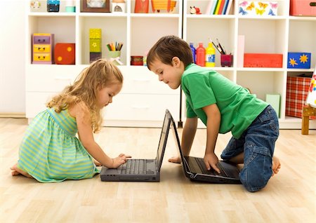 simsearch:400-04575374,k - Kids playing on laptops - boy teaching little girl what key to press Stock Photo - Budget Royalty-Free & Subscription, Code: 400-04173025