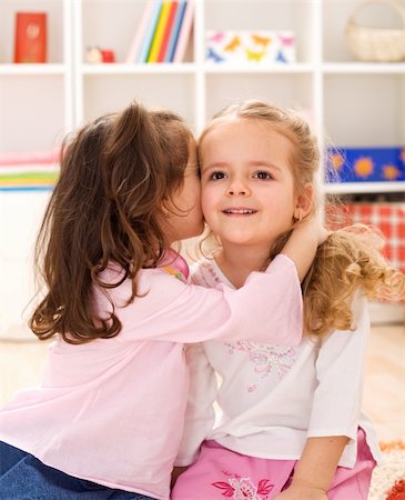 simsearch:400-05108874,k - Little girls sharing a delightful secret Photographie de stock - Aubaine LD & Abonnement, Code: 400-04173032