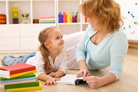 simsearch:400-04131892,k - Story time with mom - little girl and woman reading laying on the floor Stockbilder - Microstock & Abonnement, Bildnummer: 400-04173058