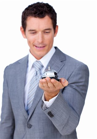 picture man at hotel desk checking in - Attractive caucasian businessman showing a service bell against a white background Stock Photo - Budget Royalty-Free & Subscription, Code: 400-04184017