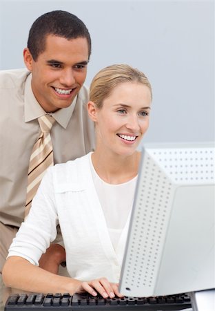 Joyful manager helping a businesswoman with her computer in the office Stock Photo - Budget Royalty-Free & Subscription, Code: 400-04184228