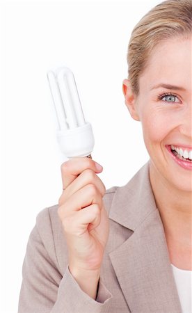 simsearch:400-04626612,k - Close-up of a businesswoman holding a saving energy light bulb against a white background Foto de stock - Super Valor sin royalties y Suscripción, Código: 400-04184322