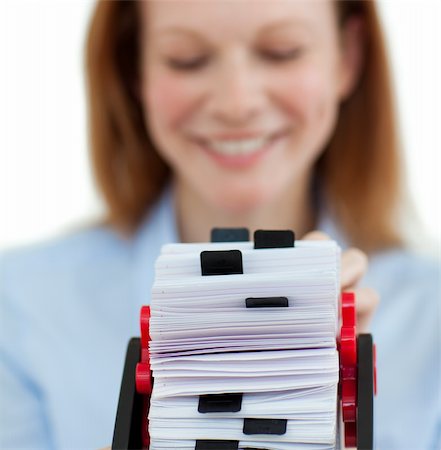 Close-up of a smiling businesswoman holding her business card holder against a white background Stock Photo - Budget Royalty-Free & Subscription, Code: 400-04184350
