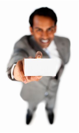 simsearch:400-05718318,k - Smiling ethnic businessman holding a white card against a white background Foto de stock - Super Valor sin royalties y Suscripción, Código: 400-04184372