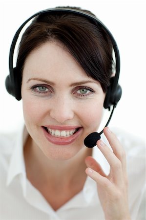 simsearch:400-03912315,k - Smiling customer service agent with headset on against a white background Photographie de stock - Aubaine LD & Abonnement, Code: 400-04184453