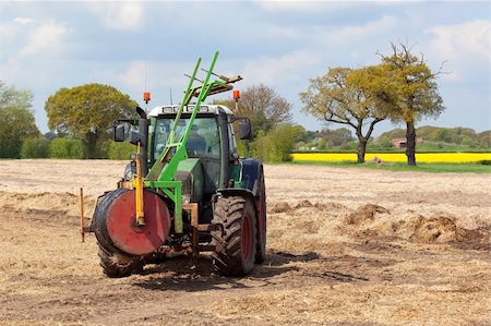 polythene - agricultural landscape with a tractor equipped for removing protective polythene from rows of overwintered carrots Stock Photo - Budget Royalty-Free & Subscription, Code: 400-04184772